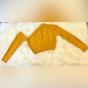 One-shoulder crop sweater.